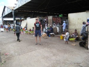 Photo: The main market in Moshi with many small vendors of fruits and vegetables. Note the meat hanging in the open.